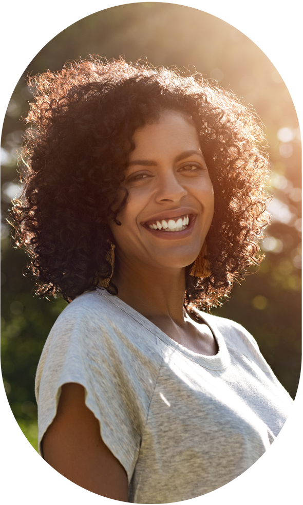 woman smiles while outside in the sun